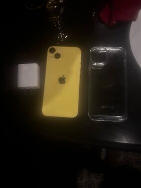 Apple Yellow iPhone 14 Plus with Clear Protective Case and Charger